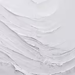 a snow covered ground with white waves of snow