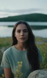 a woman in a field is staring to the right
