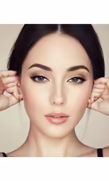 a woman with dark hair and light eyeshadp