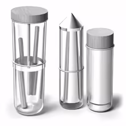 three silver objects that include metal pepper mill, sugar shaker, and spice mill