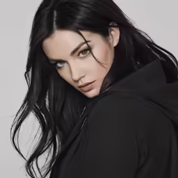 a woman with long black hair wearing a black jacket