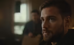 a man with a beard looking at the camera