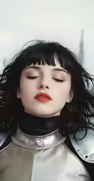 a young lady wearing metallic clothing with her hair blown back