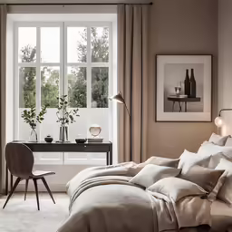 a bedroom with a bed, desk and chairs