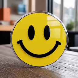 a yellow smiley face clock with black eyes