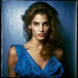 a beautiful woman posing for a photo in a blue dress,a beautiful woman in a blue dress posing for a portrait
