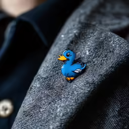 a person wearing a tie with a bird patch