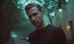 a male with a short undercut and a bald face
