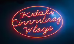 a neon sign that reads, kudak cinema west