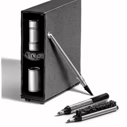 a pen with two empty cans on top and a metal cup in the bottom
