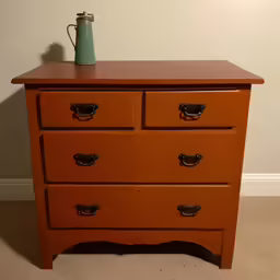 a tall dresser in an empty room with a teapot on top