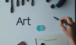 a person holding a pencil over a piece of paper