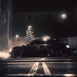 a car on the street at night with the lights on