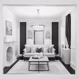 black and white photo of a living room with furniture