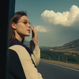 the woman is leaning against the side of a car and talking on her phone