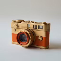 an antique camera is photographed on a plain surface