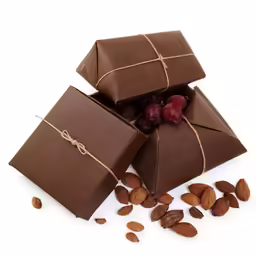 almonds and chocolate in pieces next to a wrapped box