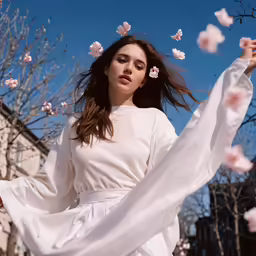 a woman with a white dress standing in the sun