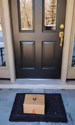 a box on the ground in front of a door