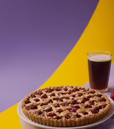 a plate of food sitting next to a glass of beer