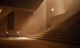 some chairs on the floor under some stairs