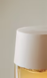a yellow liquid sits in the bottom of the bottle