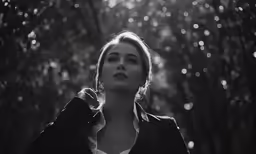 a woman that is in the woods with trees
