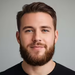 a man with beard and blue eyes smiling