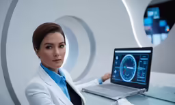 a woman sitting at a desk with her computer