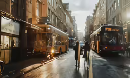 two large buses are parked on the side of the street