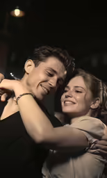 a couple are dancing in the dark in their evening dresses
