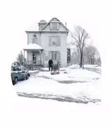 a white house that is in the snow