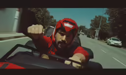 a man is riding on a red motorcycle