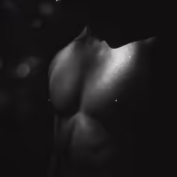 black and white photo of the side of a shirtless man