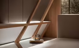 candle light placed on the edge of an artistic desk