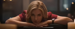 a woman leaning over the back of a chair while wearing a red dress