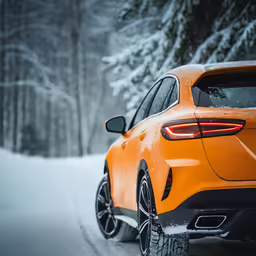 the rear end of an orange suv in the snow