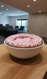 a very large fancy cake in a bowl on the counter
