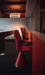 the bar in the restaurant has all red seats