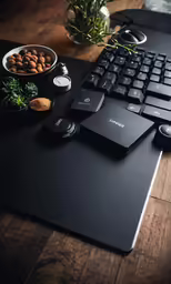 black keyboard sitting on a mouse pad with other items next to it
