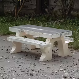 a white bench sitting in front of some bushes and grass