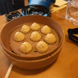 a bowl with several balls of peanut butter on top of it
