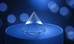 a clear plastic object sitting on top of a blue table