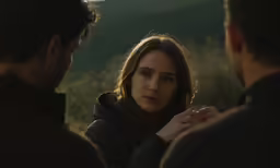 a woman looking at two men and staring