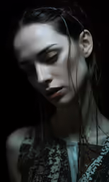 a girl with dark hair and white make up