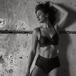 a women that is standing in a black and white photo