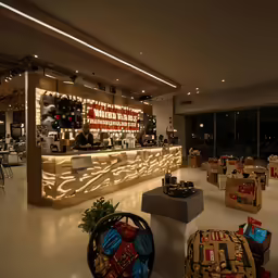 a large open lobby with many tables and luggage