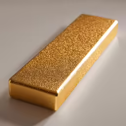 a gold metal object sitting on a white table