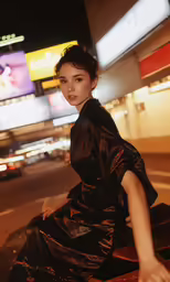 a girl posing in front of a very large building