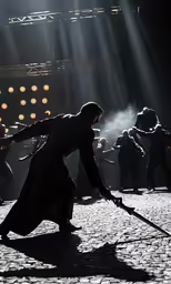 the man is working on the show with his cane